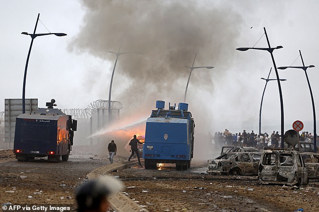 Moroccan security forces use water canon to disperse the crowds at Spain's north Africa's Cueta enclave